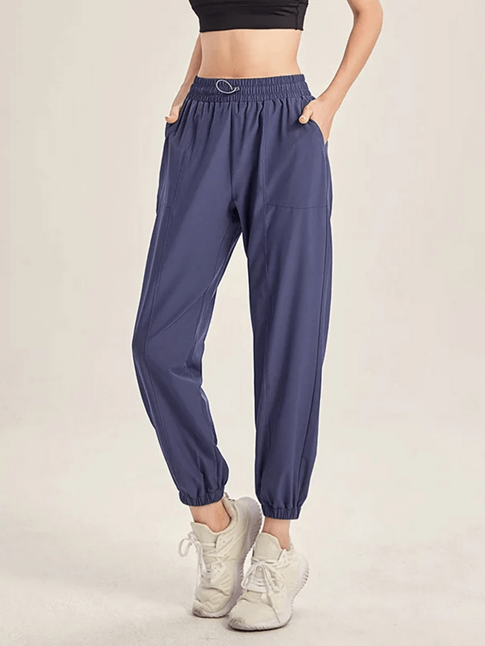 Blue stylish drawstring joggers for women, perfect for yoga, gym, running, and dance. Comfortable and flexible design with pockets.